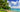 Palm trees and canoes on a quiet beach in Kiribati.